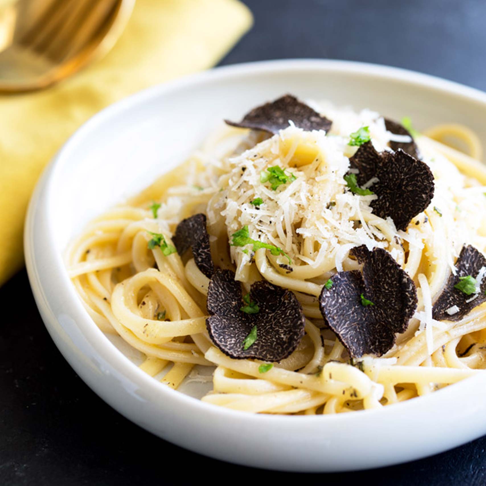 Green palm leaf beside two blank white cards on a white background.