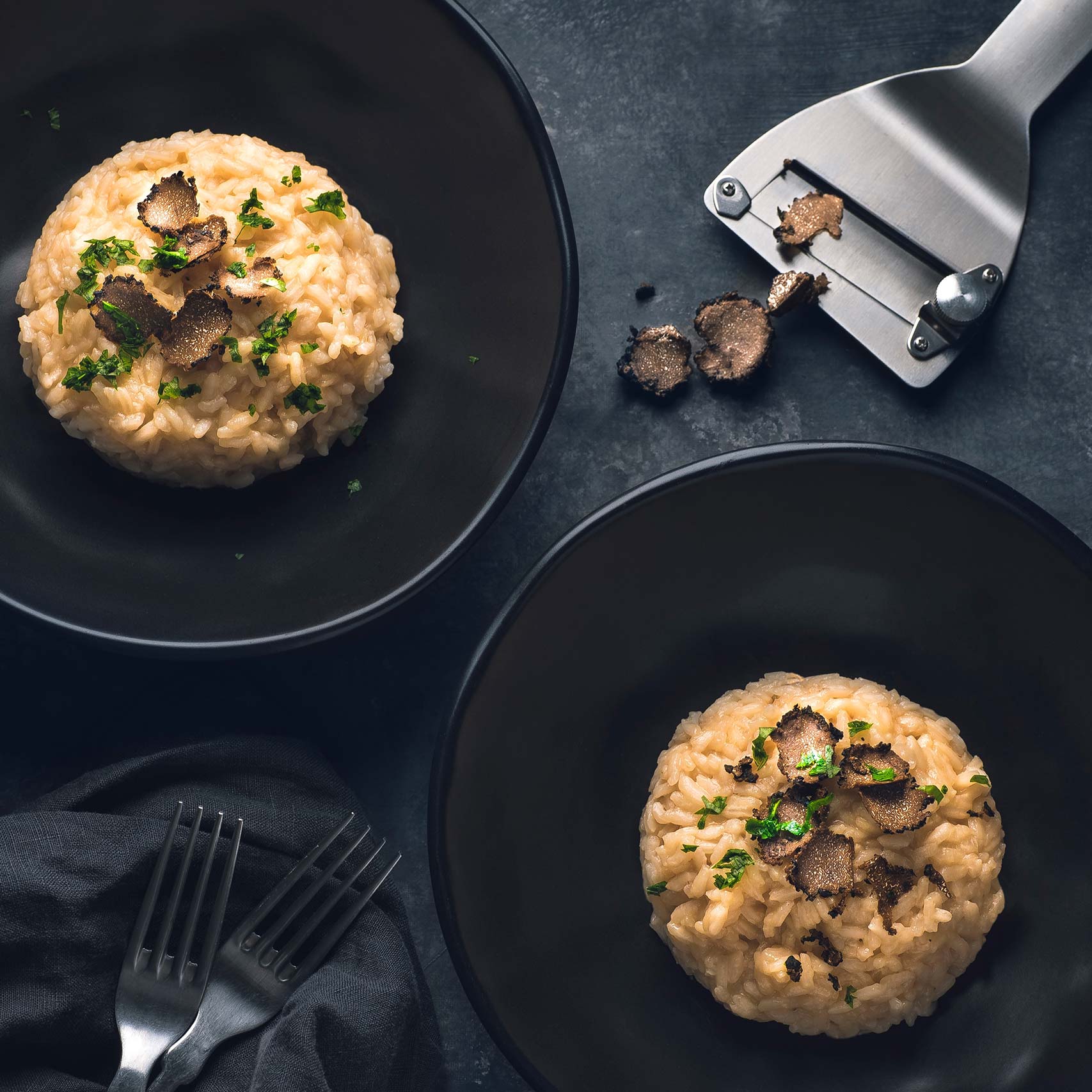 A single green leaf in a clear glass of water on white background.