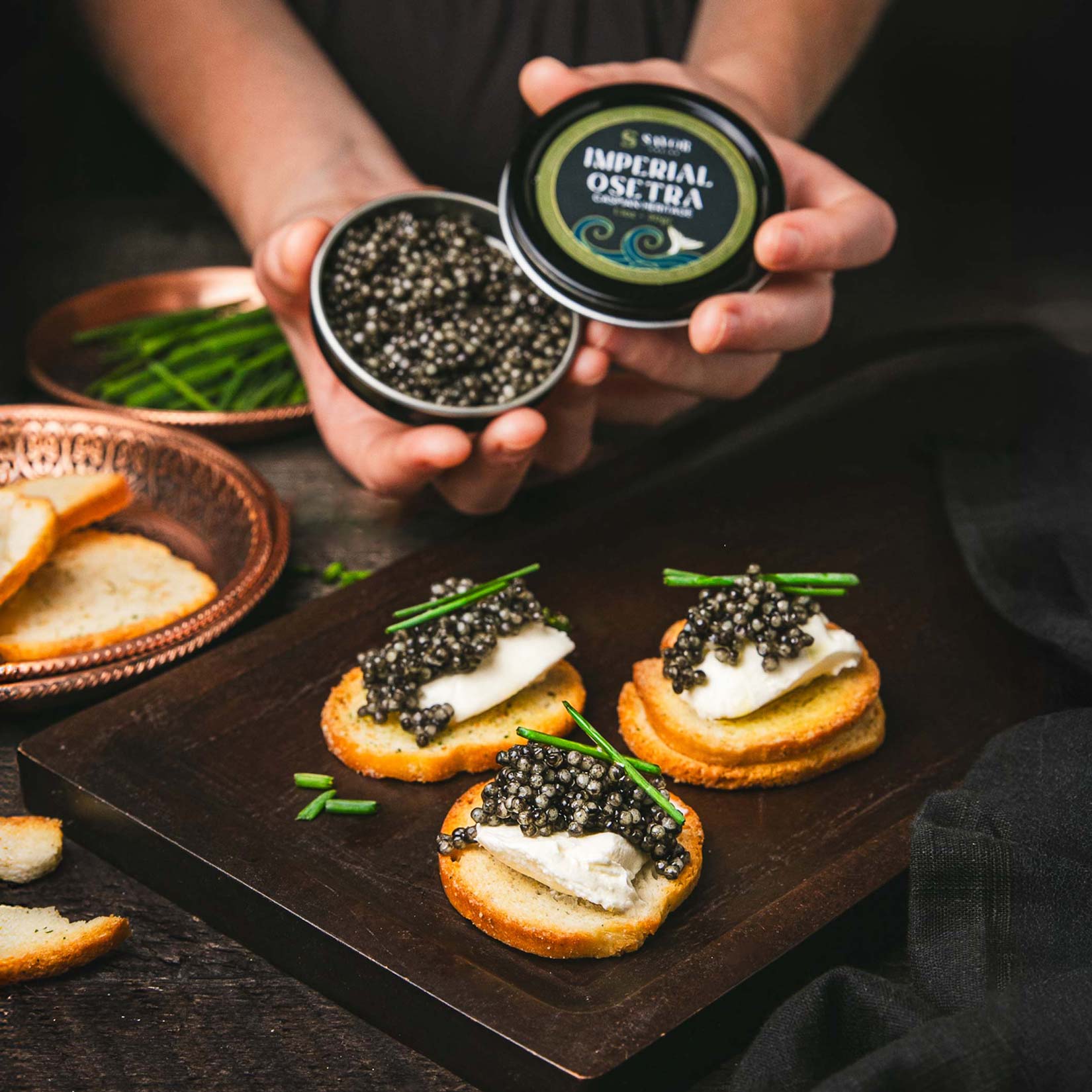 A single green leaf in a clear glass of water on white background.