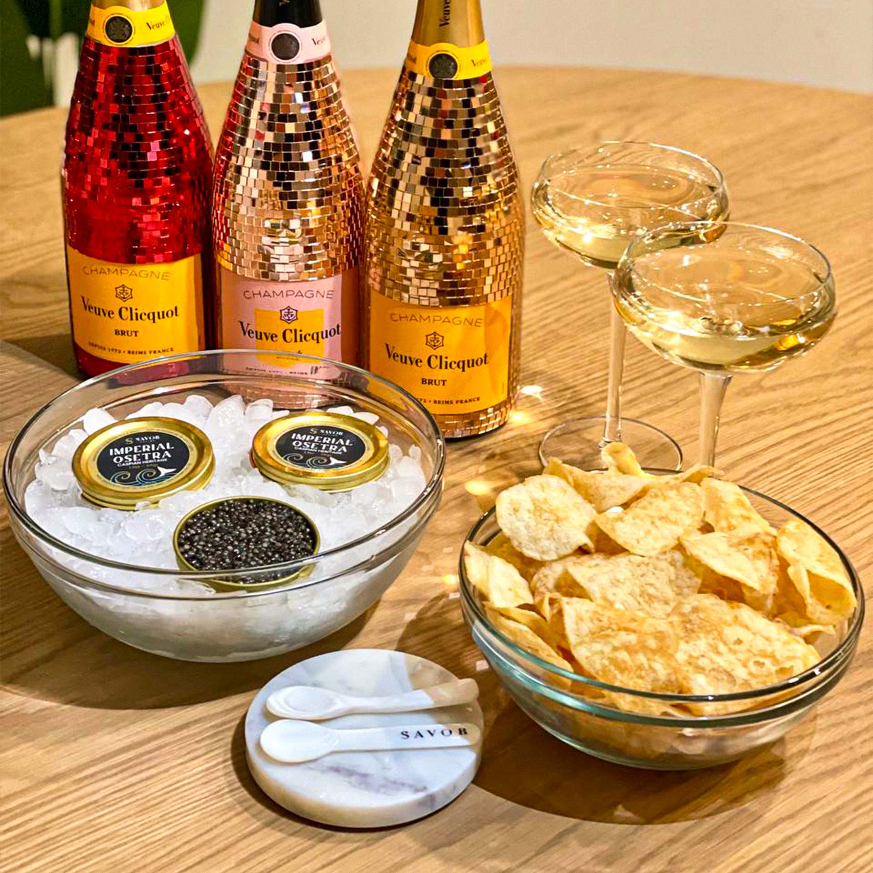 A single green leaf in a clear glass of water on white background.