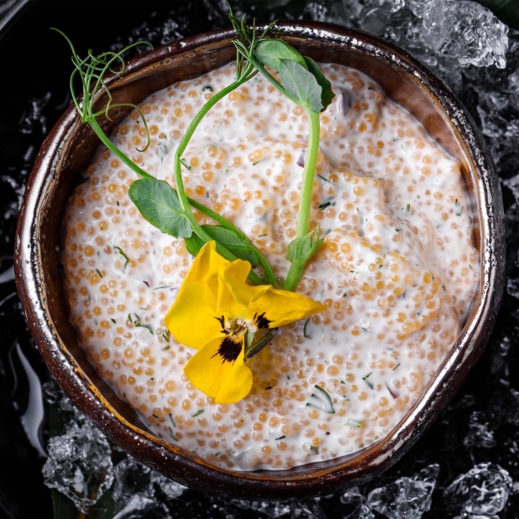 Green palm leaf beside two blank white cards on a white background.