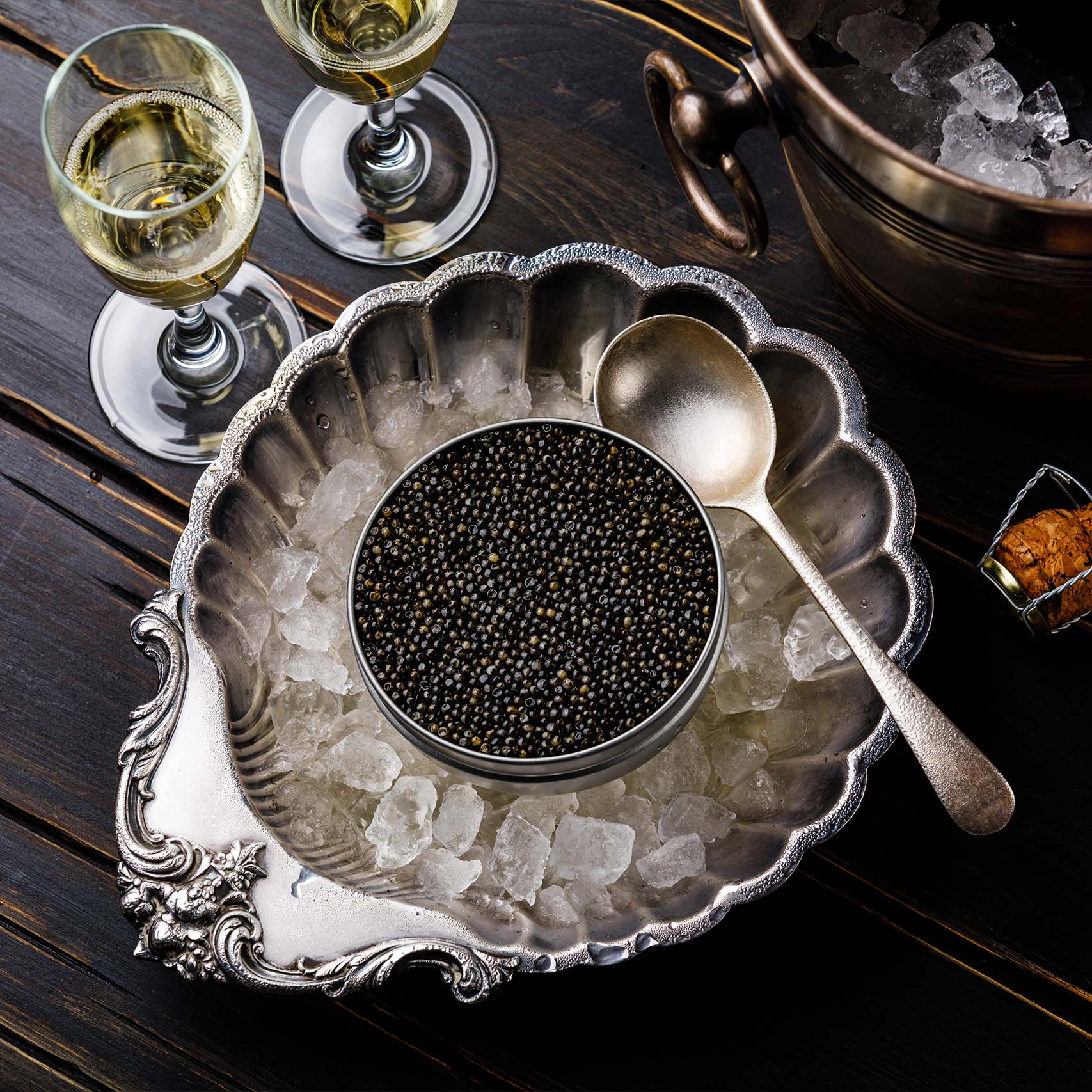 A single green leaf in a clear glass of water on white background.