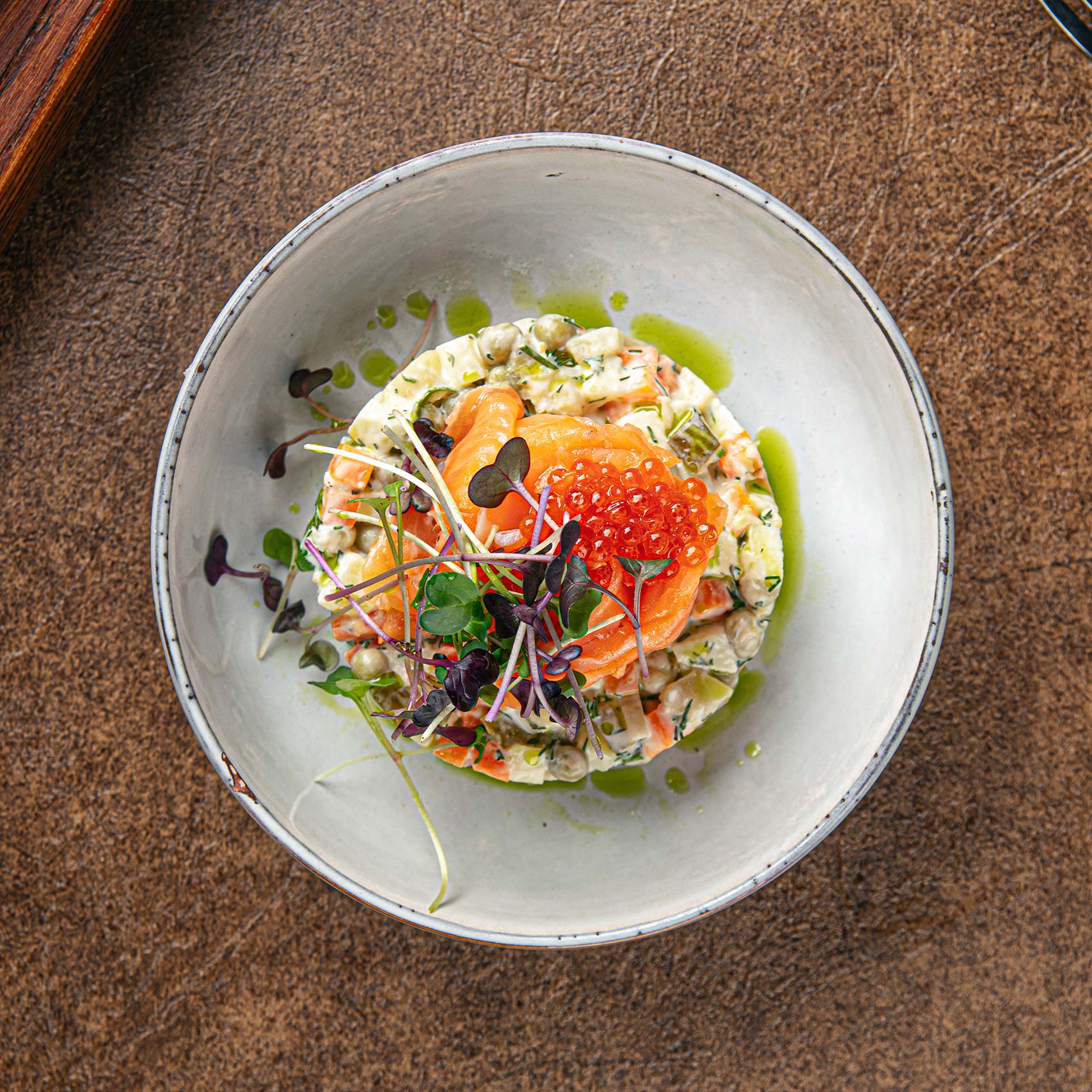 Green palm leaf beside two blank white cards on a white background.