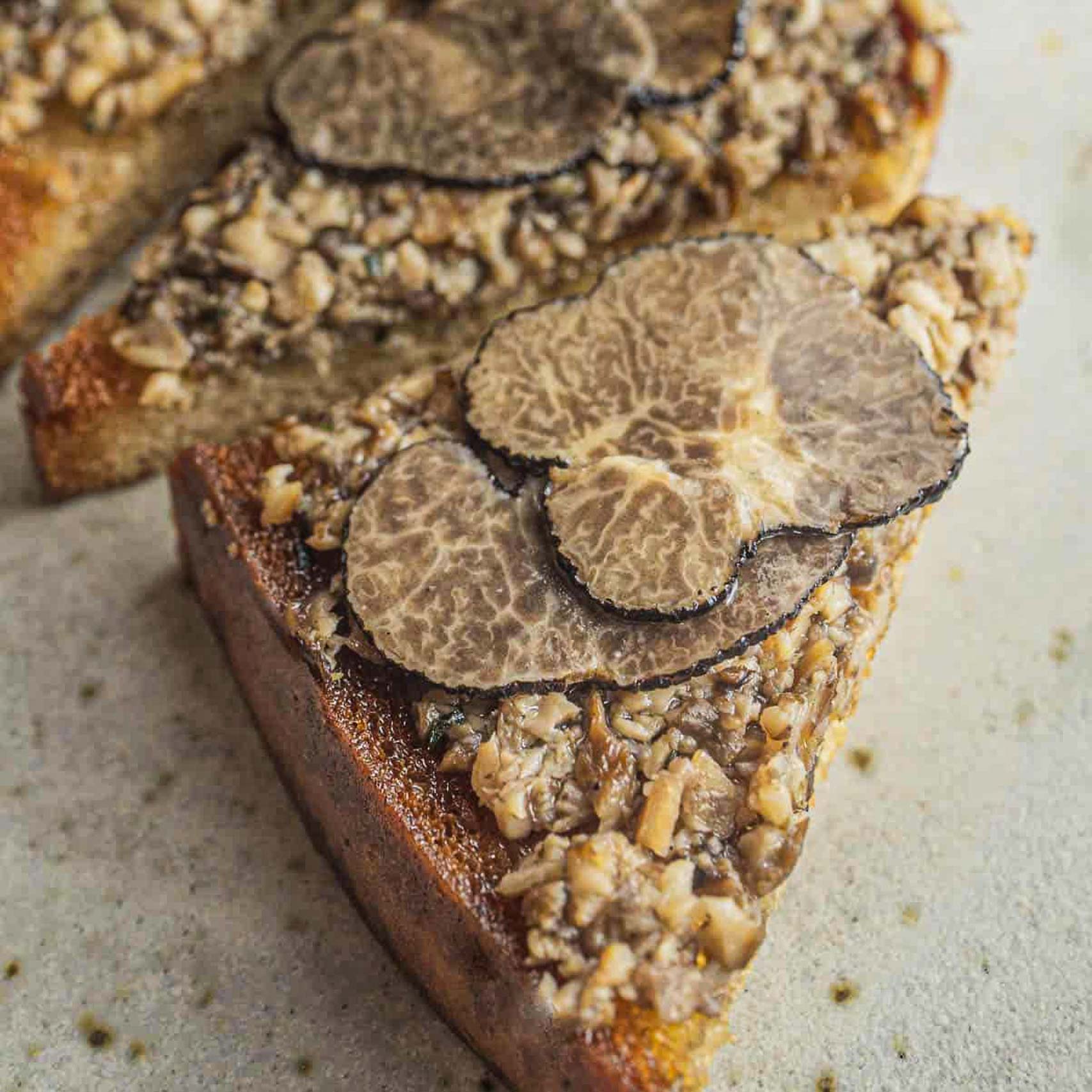Green palm leaf beside two blank white cards on a white background.