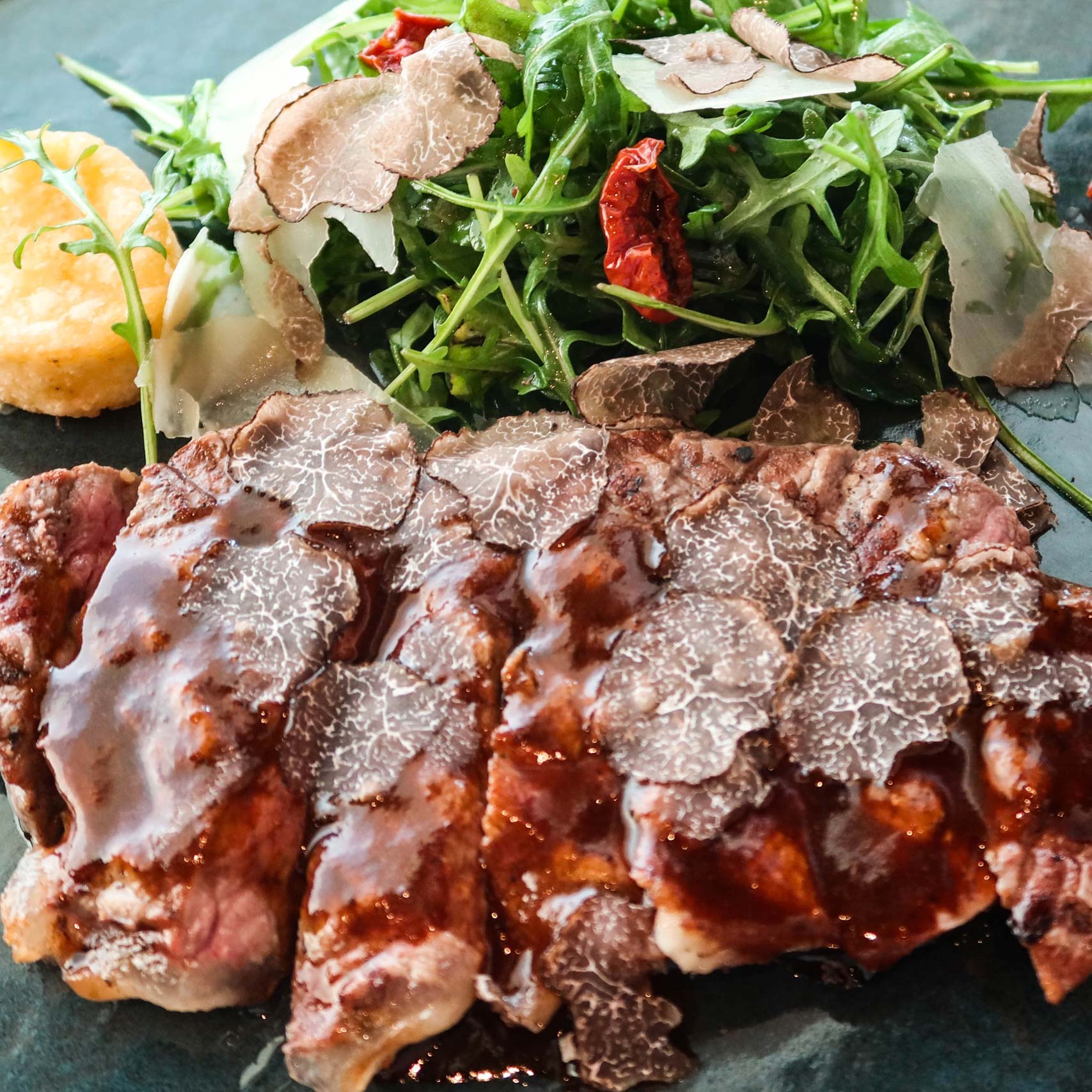 Green palm leaf beside two blank white cards on a white background.