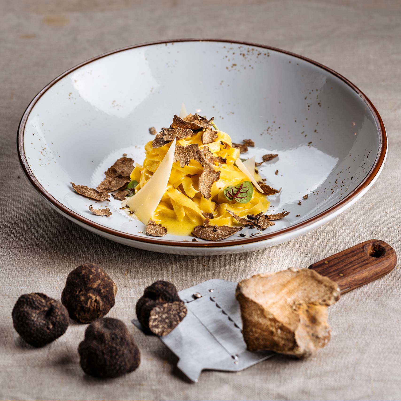 Green palm leaf beside two blank white cards on a white background.