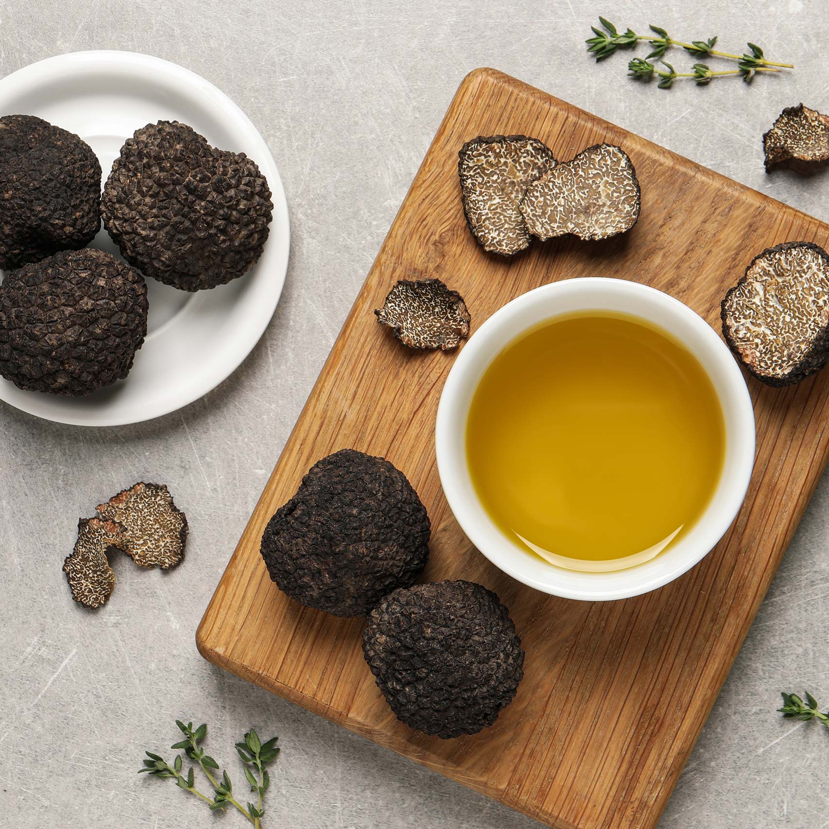 A single green leaf in a clear glass of water on white background.