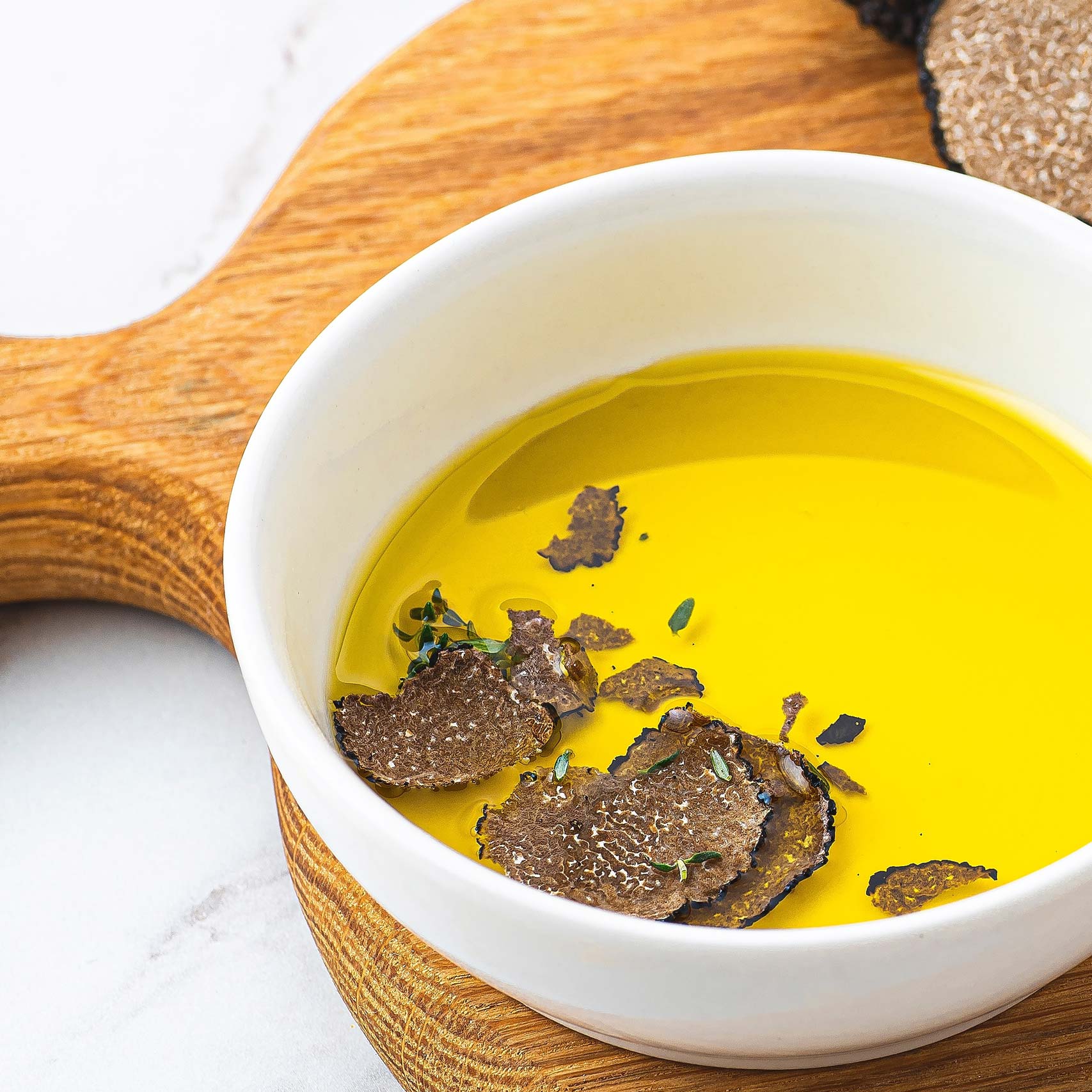Green palm leaf beside two blank white cards on a white background.