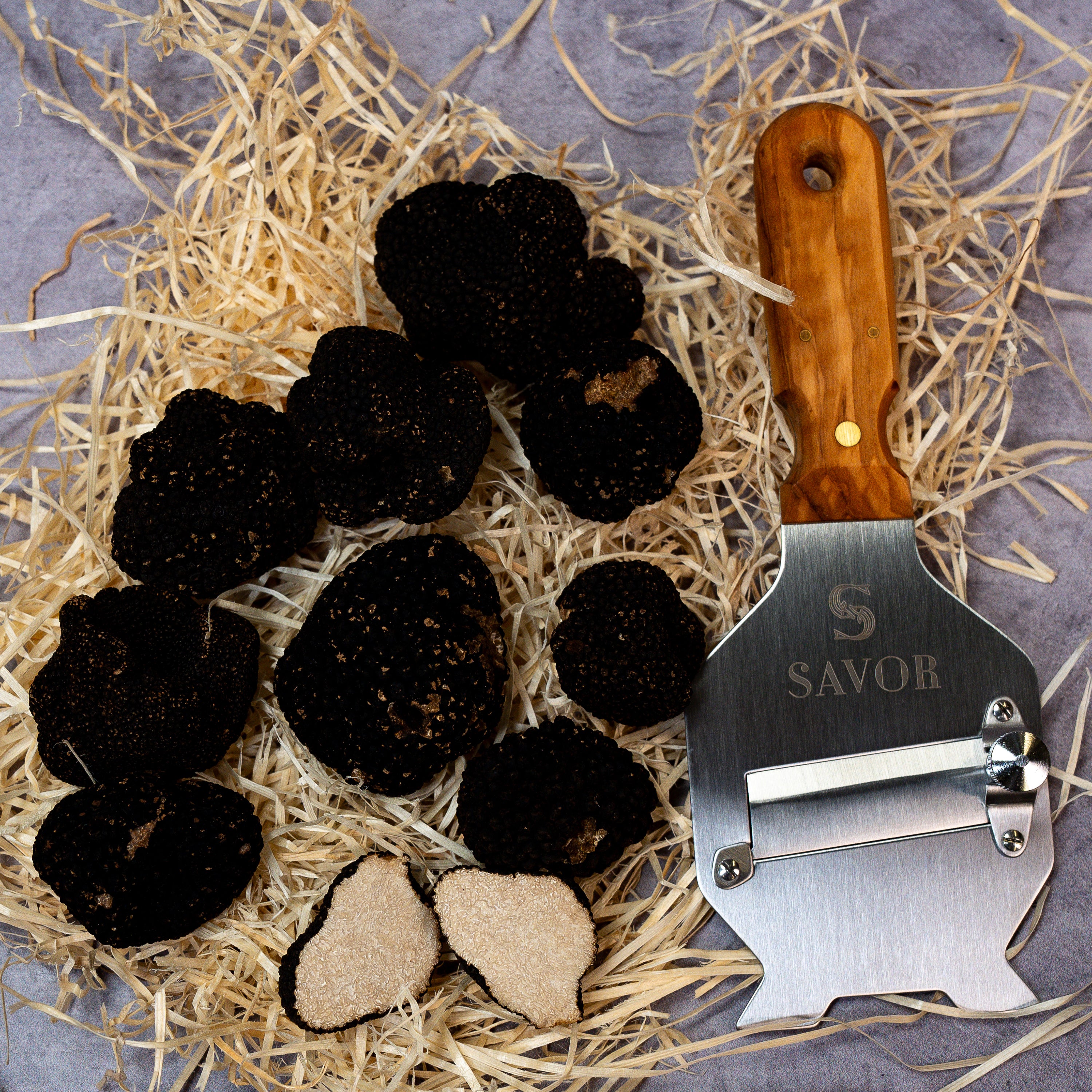 A single green leaf in a clear glass of water on white background.
