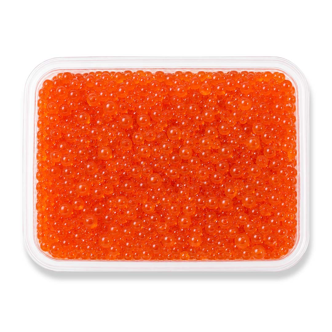 Container of wild-caught Chum salmon roe featuring large vibrant orange Ikura pearls in a clear tray with product label, showcasing premium ocean-fresh salmon caviar.
