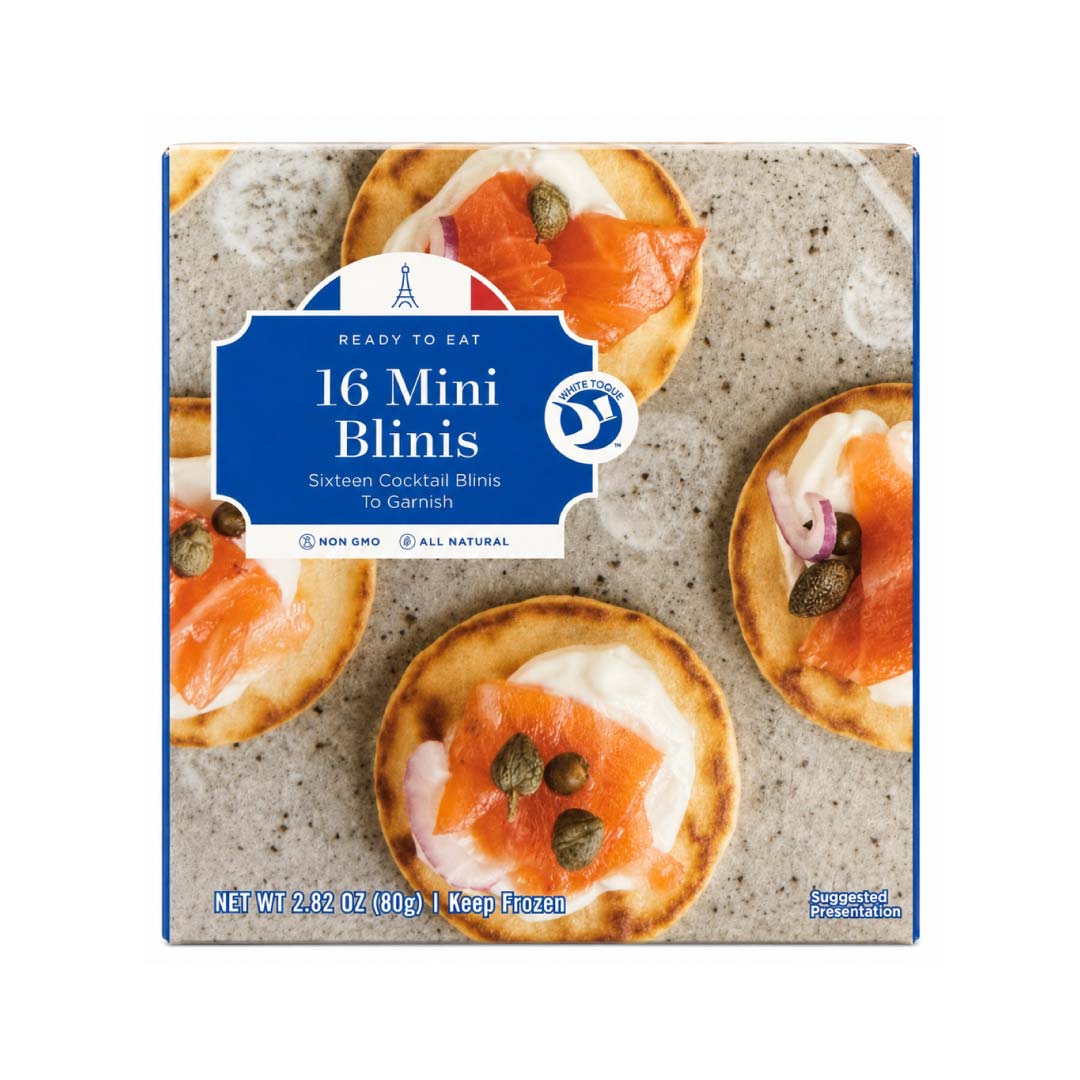 Box of 16 Mini Blinis with salmon and cream cheese garnish on a textured surface.